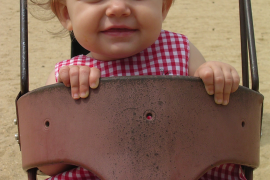 Kate as a baby in a swing