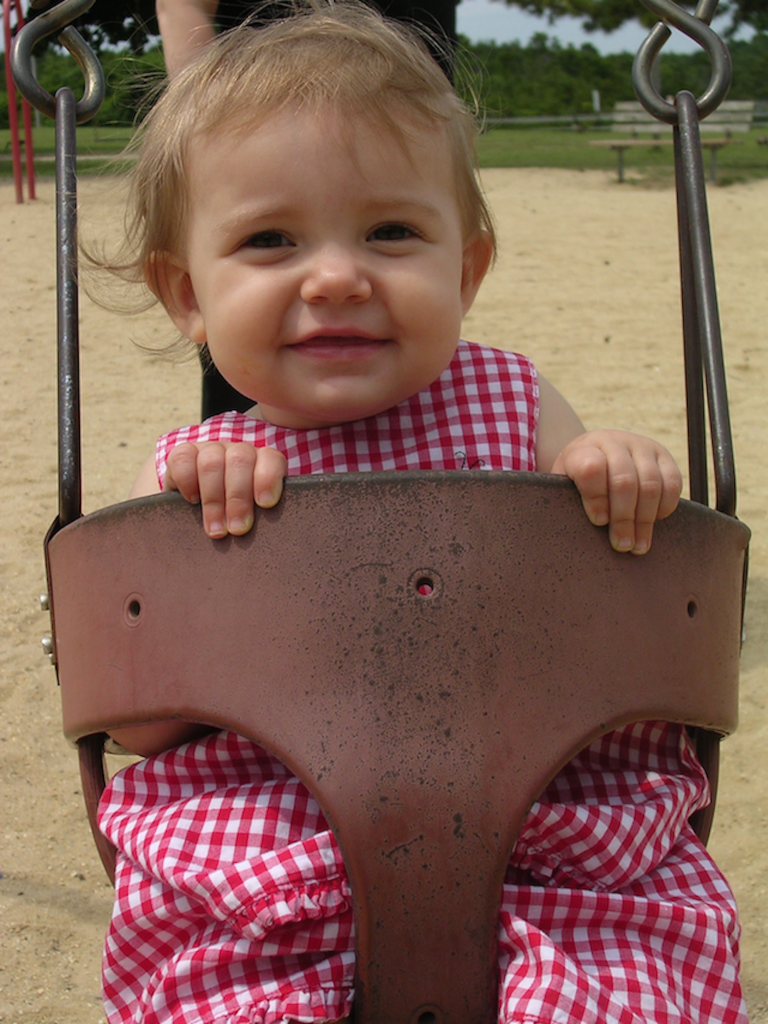 Kate as a baby in a swing