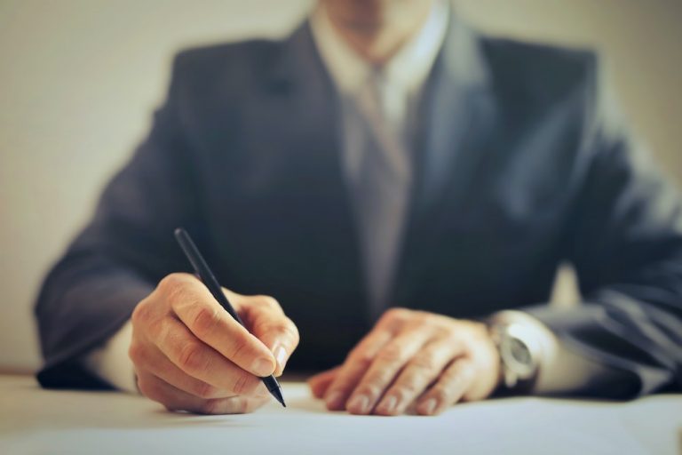 man signing contract