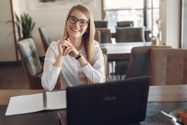 Smiling woman in front of laptop
