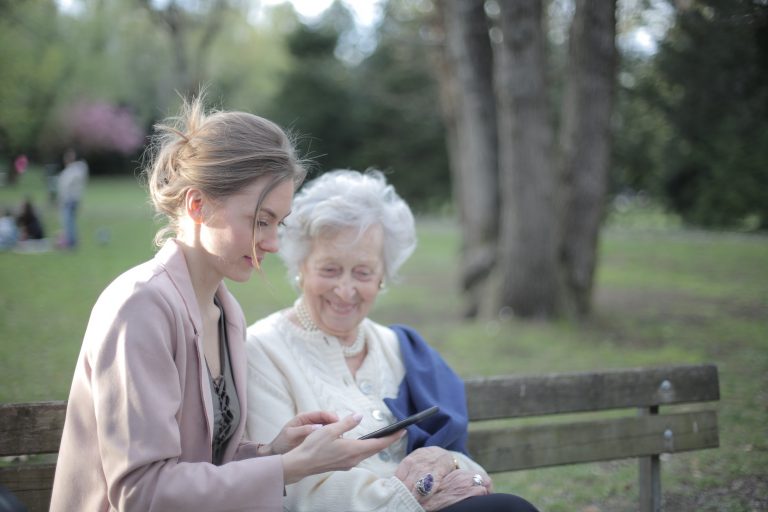 Younger woman helping an elderly woman