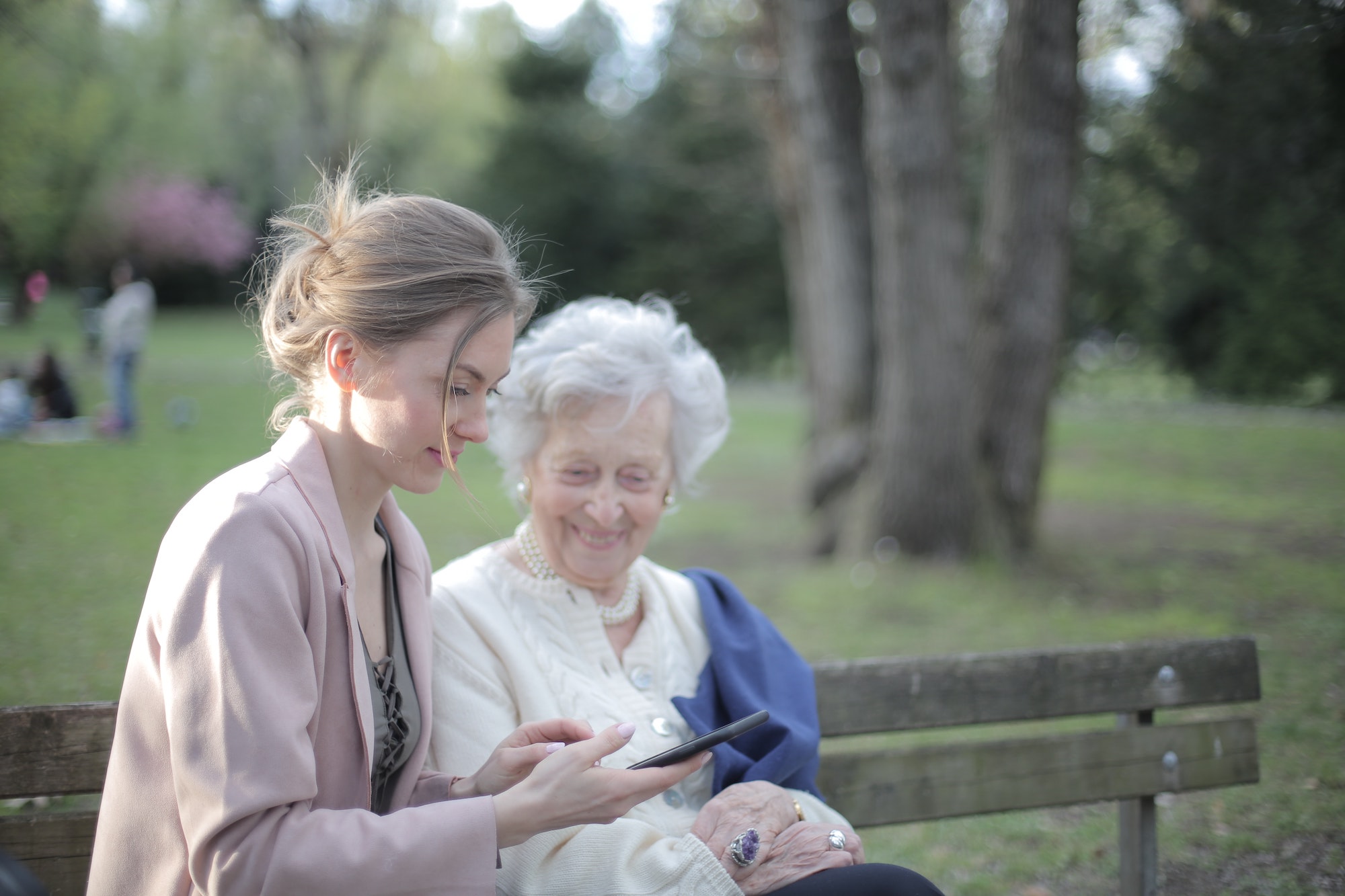 Younger woman helping an elderly woman
