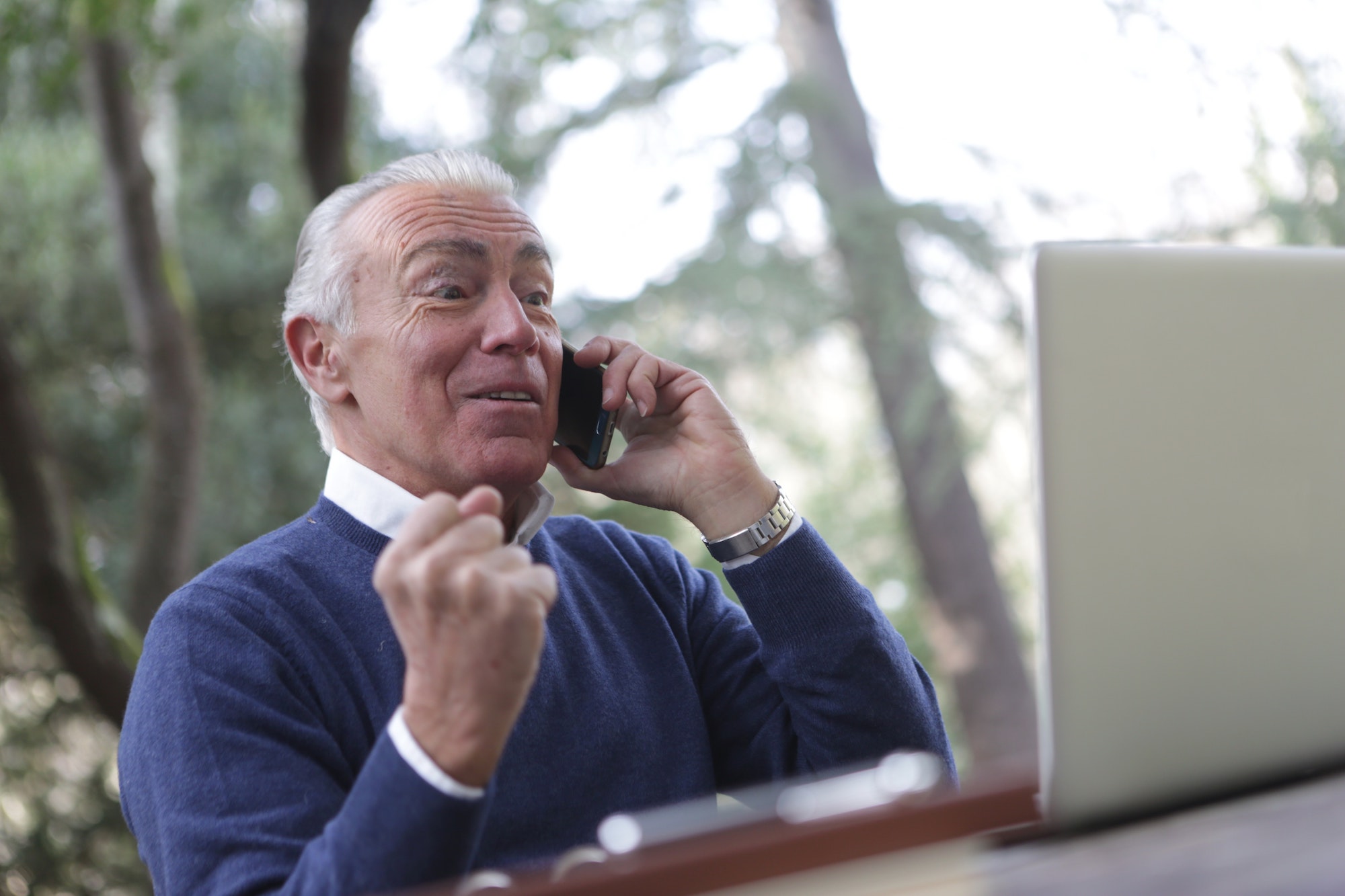 Happy older man looking at a laptop