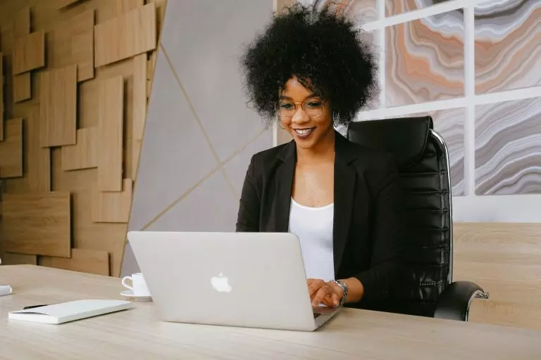 woman smiling at laptop