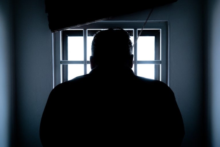man in front of a window