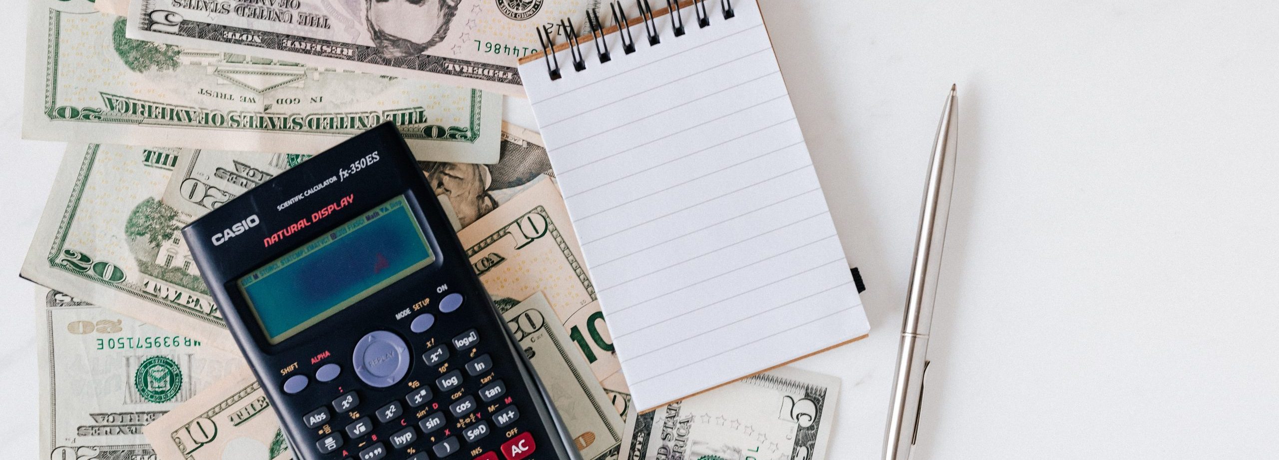 Business Management: Learning From High-Profile Celebrity Tax Problems calcutator, note pad and dollar bills