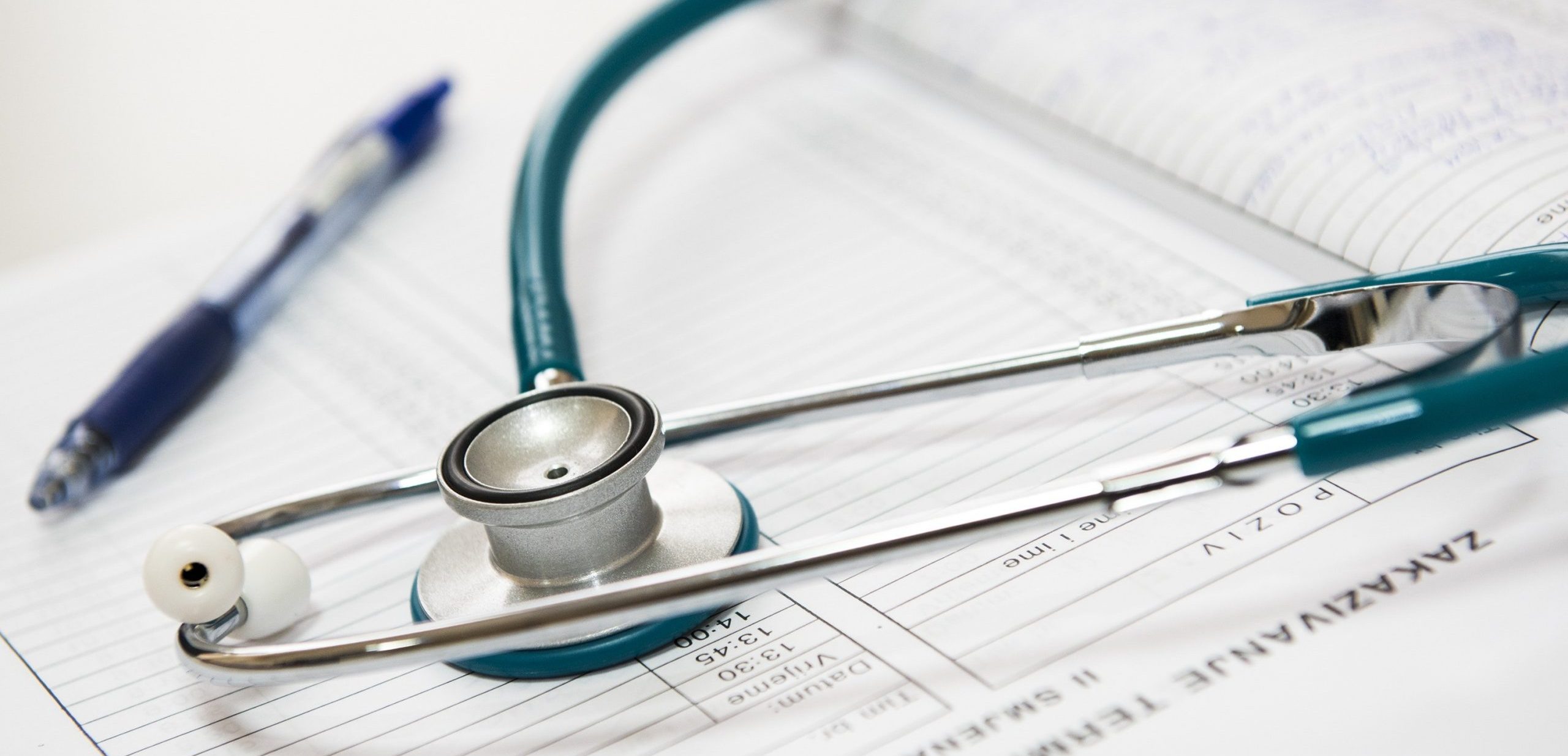 HSA Tax Deductions: Using Your Healthcare For Taxes And Retirement stethoscope and pen