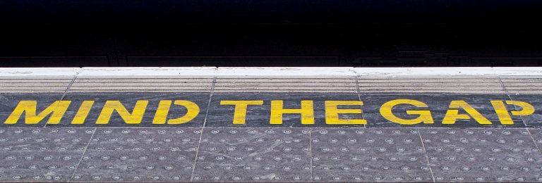 Mind the gap painted on subway floor