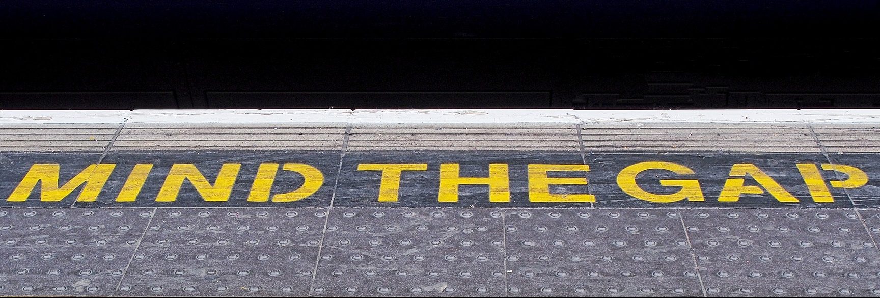 Mind the gap painted on subway floor
