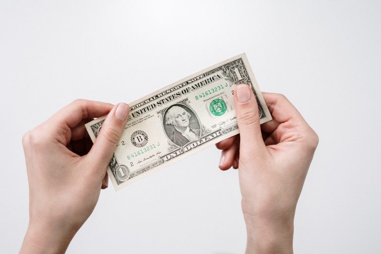 Dollar bill in hand