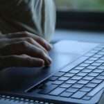 That mychart medicare kit is a scam | taxgirl Close up of hands typing on a laptop keyboard on a desk