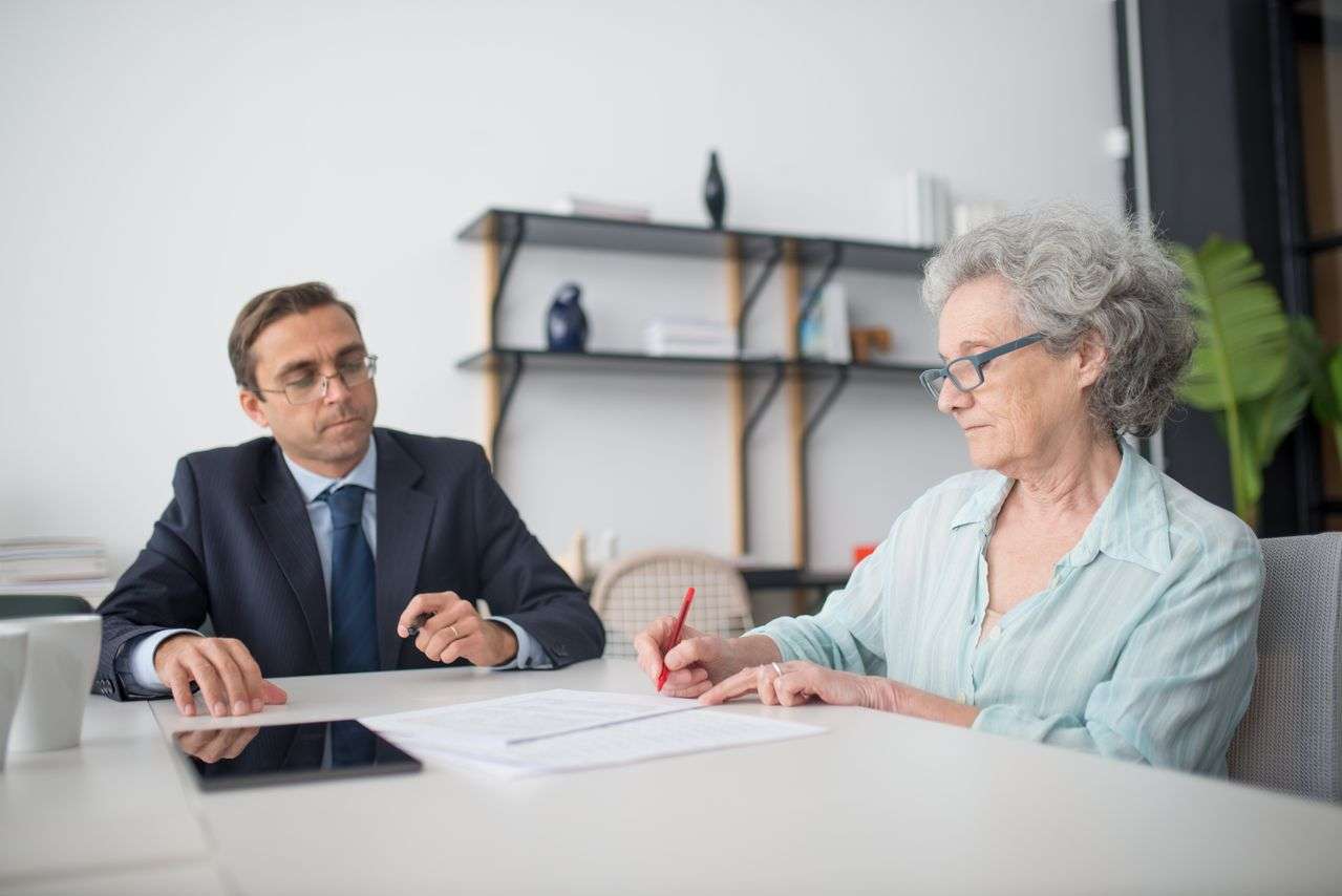 Older woman signing a trust