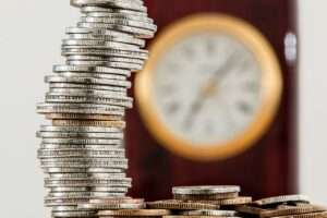 Coins and a clock to show value of savings
