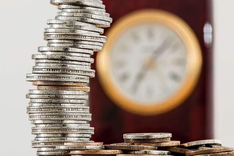 coins and a clock to show value of savings